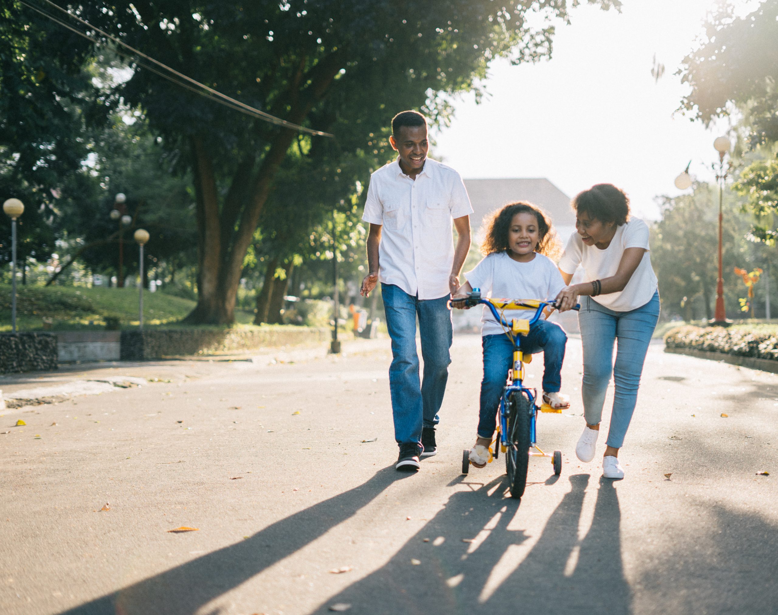 kid writing bike with parents